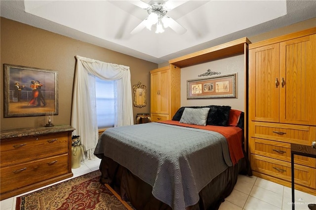 bedroom with ceiling fan and light tile patterned floors