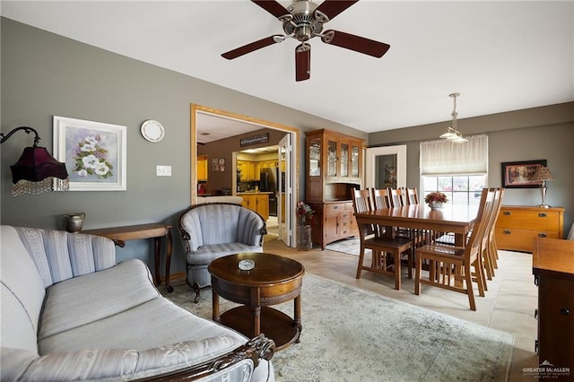 living room with ceiling fan and light tile patterned flooring