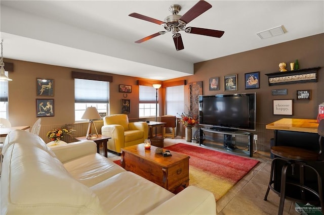 tiled living room featuring ceiling fan