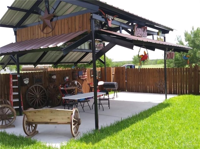 view of patio with a gazebo and fence