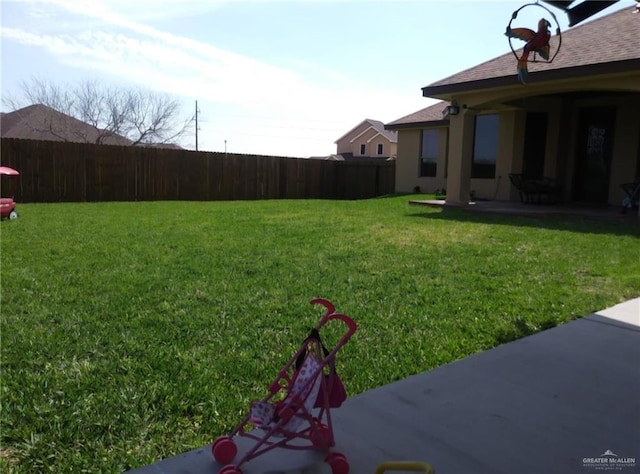 view of yard featuring a patio and fence