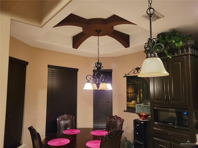 dining room with visible vents and coffered ceiling