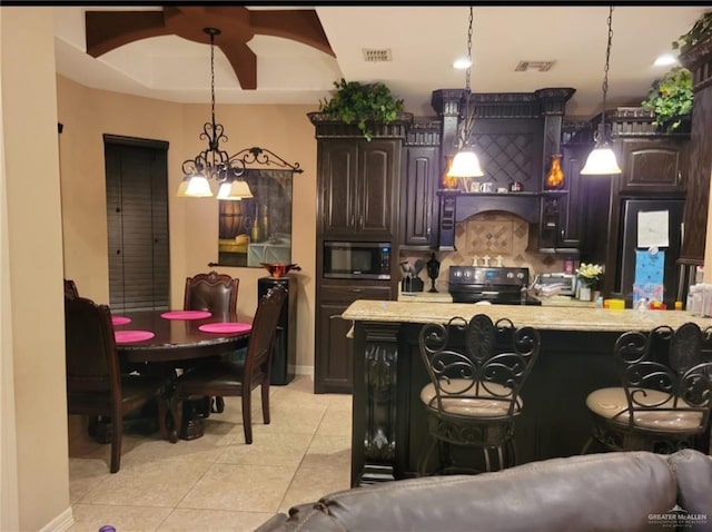 kitchen with visible vents, stainless steel microwave, black range with electric cooktop, light countertops, and light tile patterned floors