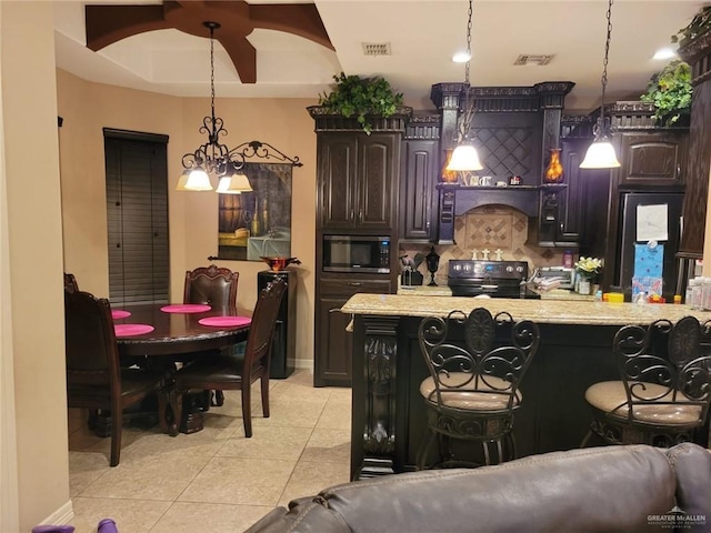 kitchen featuring stainless steel microwave, light tile patterned floors, visible vents, and range with electric stovetop