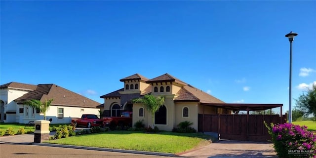 view of front of house with stucco siding, concrete driveway, and a front lawn