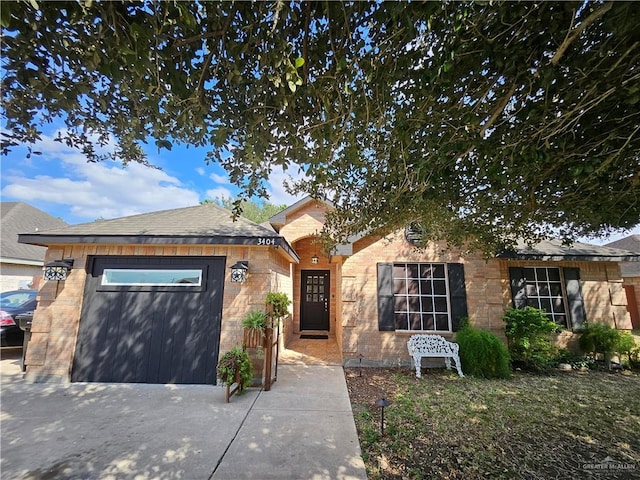 view of front of property with a garage and brick siding