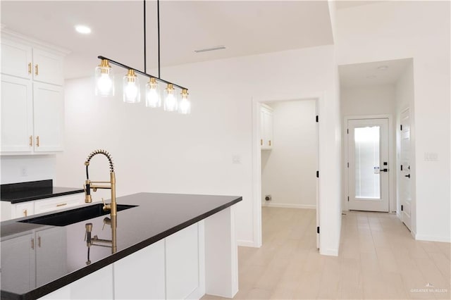 2221 N Woody St, Edinburg, TX 78541 - kitchen featuring dark countertops, white cabinets, hanging light fixtures, and recessed lighting