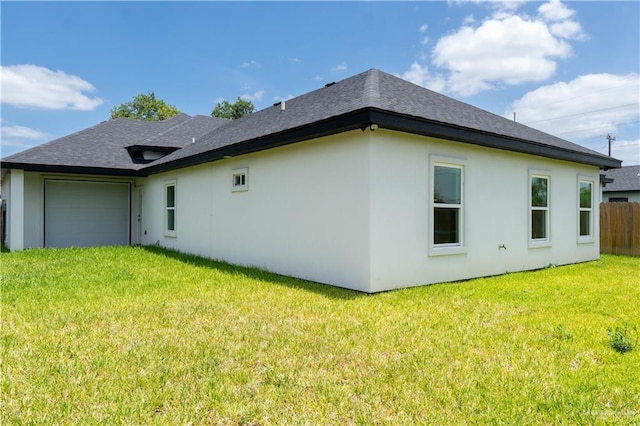 2221 N Woody St, Edinburg, TX 78541 - back of property featuring a garage, stucco siding, and a shingled roof