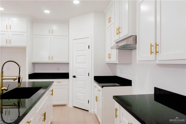 2221 N Woody St, Edinburg, TX 78541 - kitchen with under cabinet range hood, white cabinets, recessed lighting, dark stone countertops, and black electric cooktop