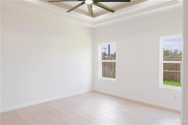 2221 N Woody St, Edinburg, TX 78541 - empty room featuring a raised ceiling, ceiling fan, and light wood finished floors