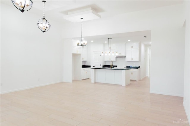 2221 N Woody St, Edinburg, TX 78541 - kitchen featuring a chandelier, dark countertops, open floor plan, white cabinets, and recessed lighting