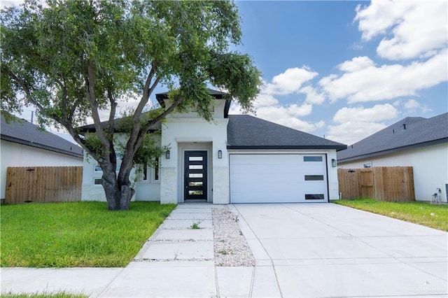 2221 N Woody St, Edinburg, TX 78541 - contemporary home featuring a garage, driveway, and stucco siding