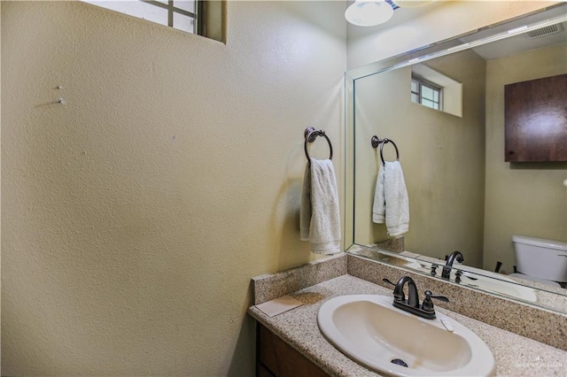 3008 S M St Unit 4, Mcallen, TX 78503 - half bathroom with vanity, toilet, and a textured wall