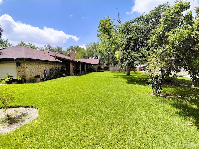 702 Clifford Dr, Weslaco, TX 78596 - view of green lawn with an attached garage