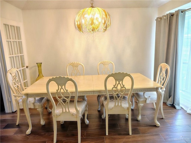 702 Clifford Dr, Weslaco, TX 78596 - dining area with a chandelier, wood finished floors, and healthy amount of natural light