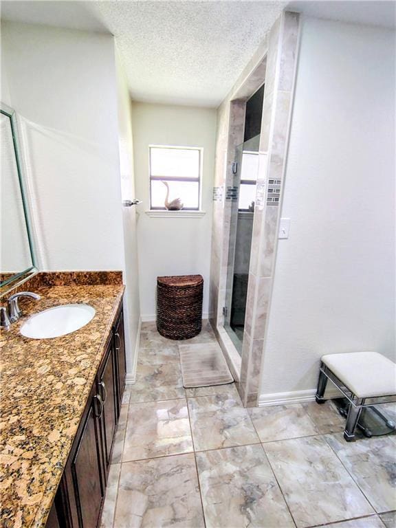 702 Clifford Dr, Weslaco, TX 78596 - full bath featuring vanity, a textured ceiling, and a stall shower