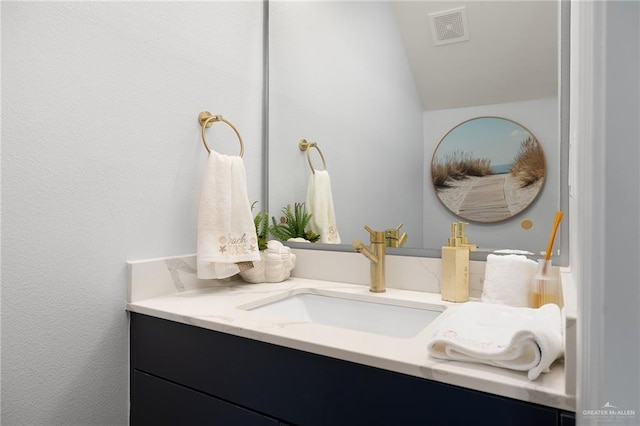 bathroom with vanity and lofted ceiling