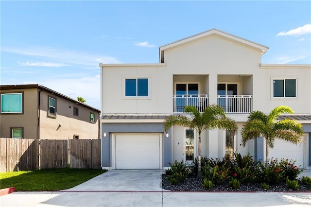 view of front of property featuring a balcony and a garage