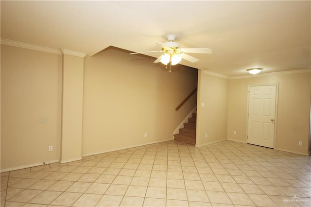 tiled spare room featuring ceiling fan and ornamental molding