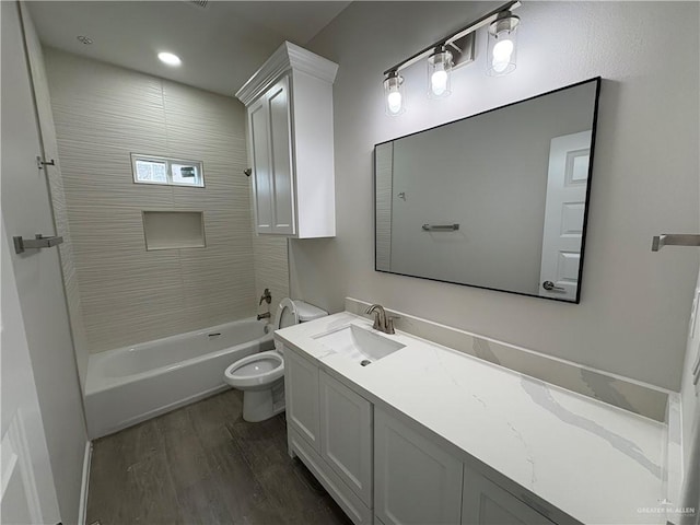 bathroom with toilet, vanity, shower / bath combination, and wood finished floors