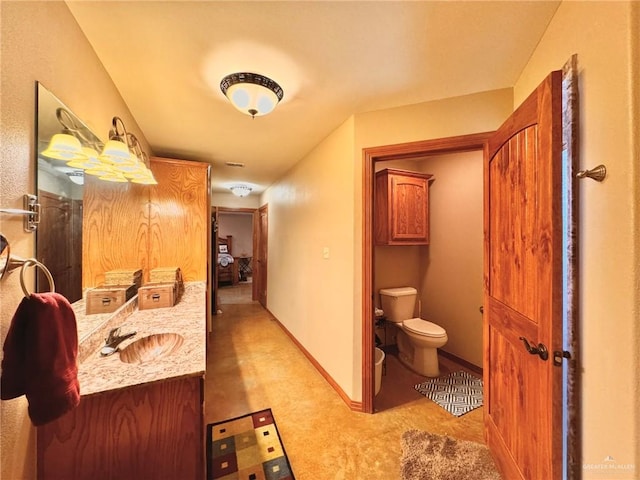 bathroom featuring vanity and toilet