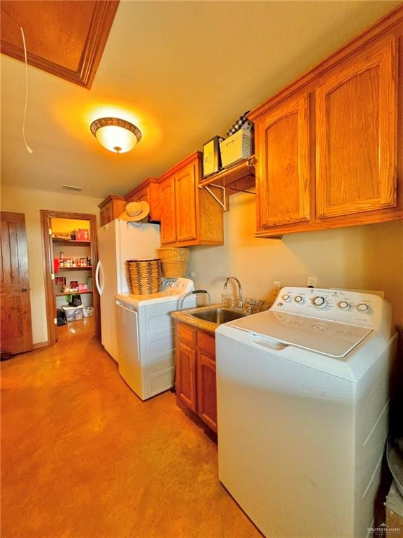 laundry area with cabinets, separate washer and dryer, and sink