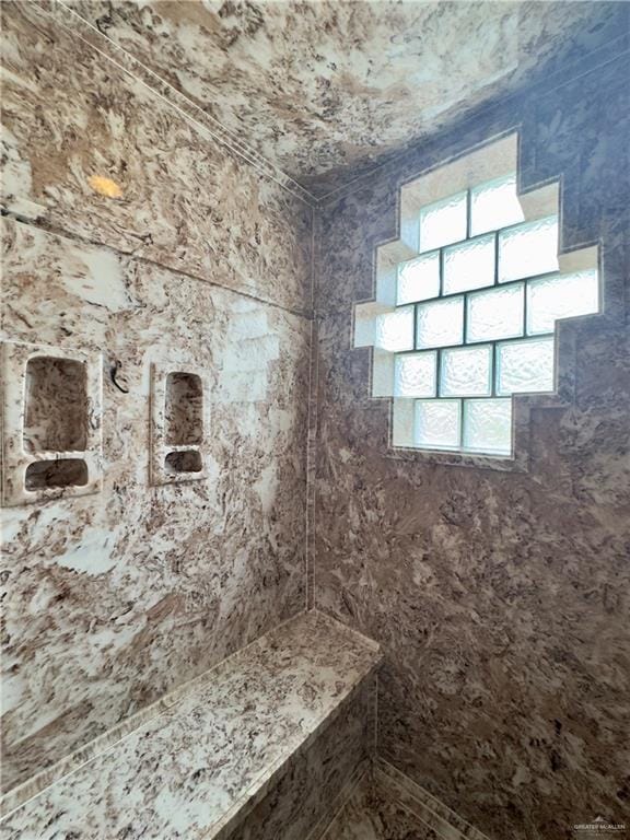 bathroom with a tile shower