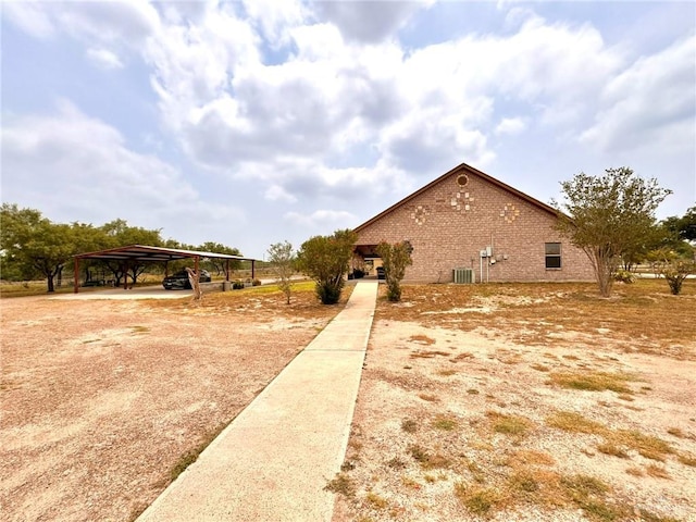 view of side of property featuring a carport and cooling unit