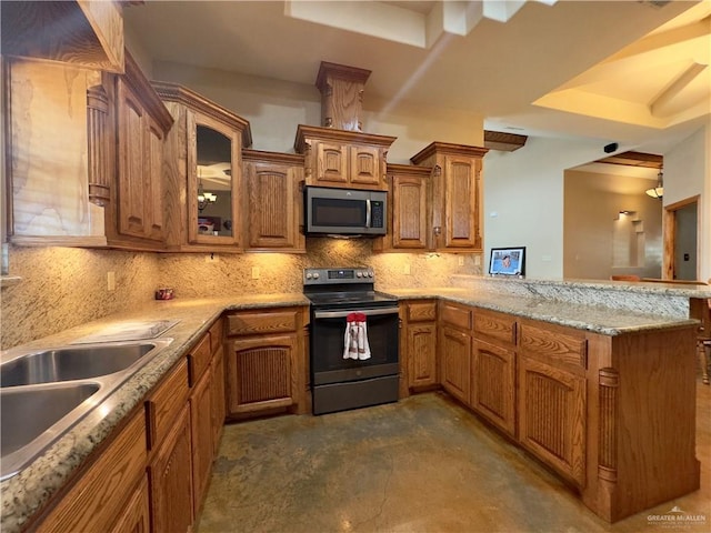 kitchen featuring sink, kitchen peninsula, backsplash, and appliances with stainless steel finishes