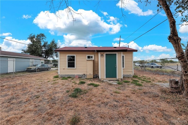 back of property with an outbuilding