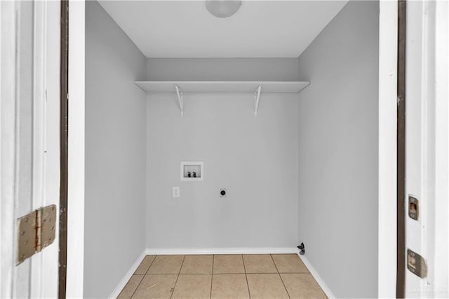 washroom featuring washer hookup, electric dryer hookup, and light tile patterned flooring