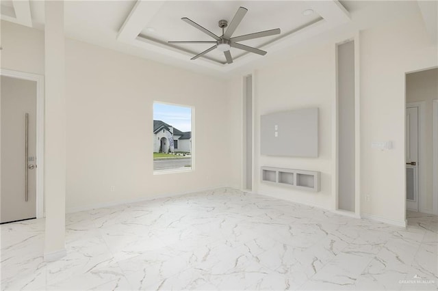 1921 Lime St, San Juan, TX 78589 - spare room with ceiling fan, a tray ceiling, marble finish floors, and baseboards