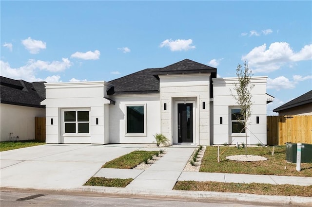 1921 Lime St, San Juan, TX 78589 - modern home with a shingled roof, stucco siding, and concrete driveway