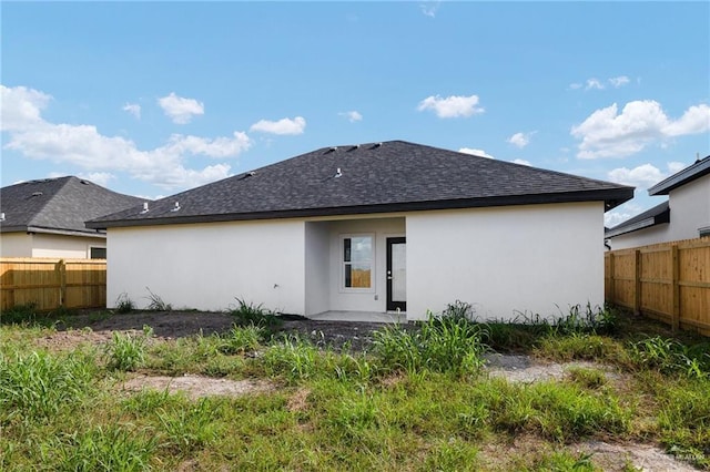 1921 Lime St, San Juan, TX 78589 - rear view of house featuring a fenced backyard, stucco siding, and roof with shingles
