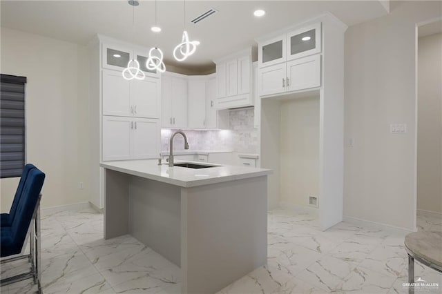 1921 Lime St, San Juan, TX 78589 - kitchen featuring a sink, light marble finish flooring, decorative backsplash, baseboards, and recessed lighting