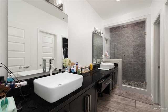 bathroom featuring tile patterned floors, vanity, and an enclosed shower