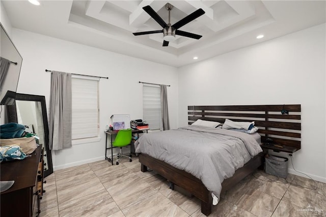 bedroom with a raised ceiling and ceiling fan