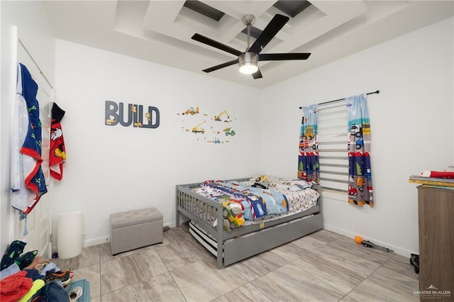 bedroom with a raised ceiling and ceiling fan