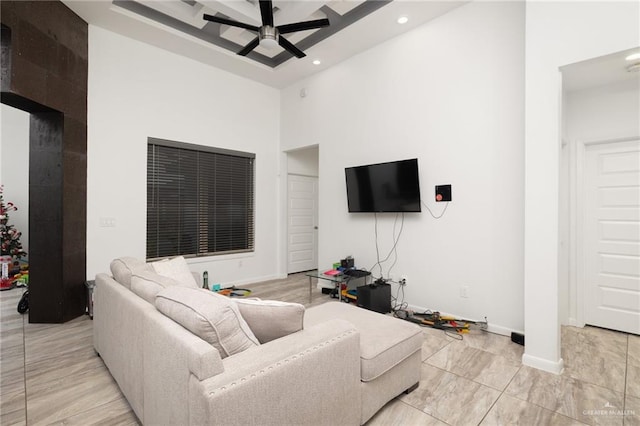 living room featuring a high ceiling and ceiling fan