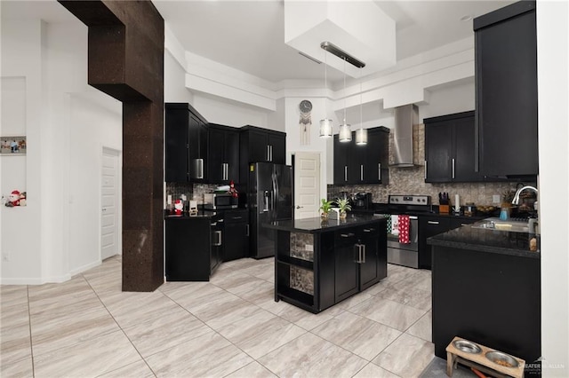 kitchen featuring sink, wall chimney exhaust hood, decorative backsplash, appliances with stainless steel finishes, and a kitchen island