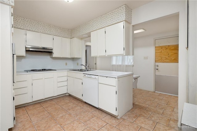 kitchen featuring dishwasher, sink, kitchen peninsula, stainless steel gas stovetop, and white cabinets