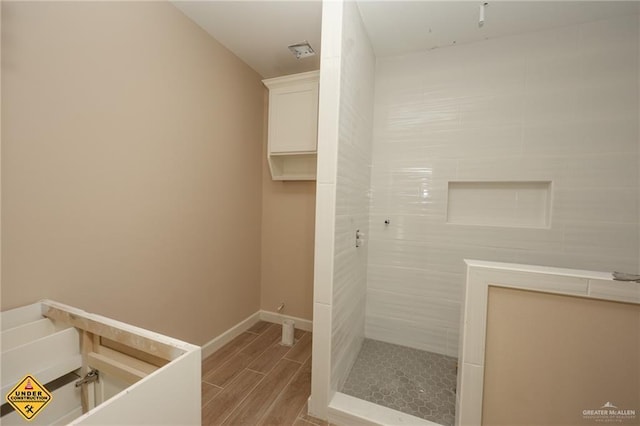 bathroom with a tile shower