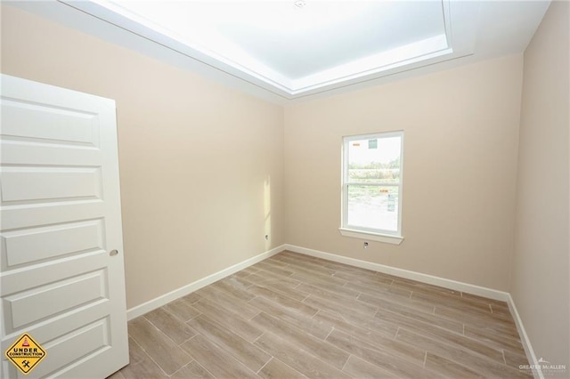 spare room featuring a raised ceiling