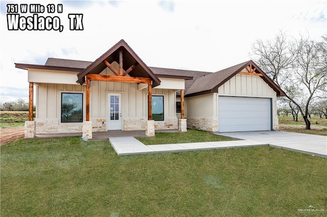 view of front facade with a garage, a porch, and a front yard