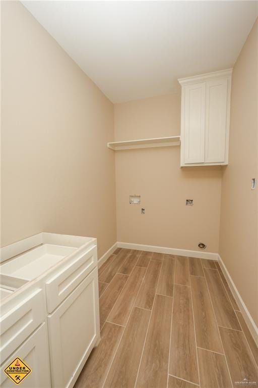 clothes washing area featuring cabinets, washer hookup, and electric dryer hookup