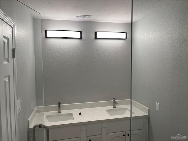 bathroom featuring vanity and a textured ceiling