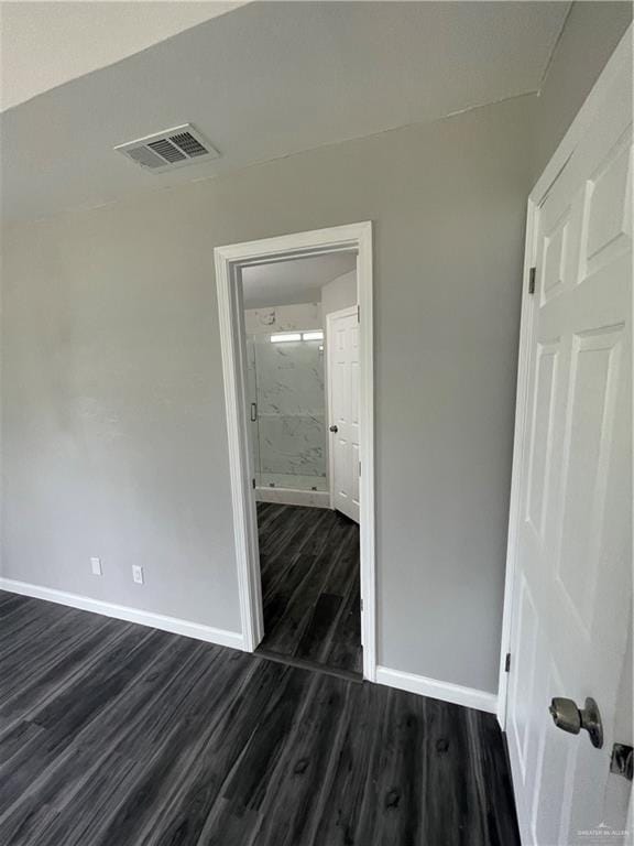 unfurnished room featuring dark hardwood / wood-style flooring