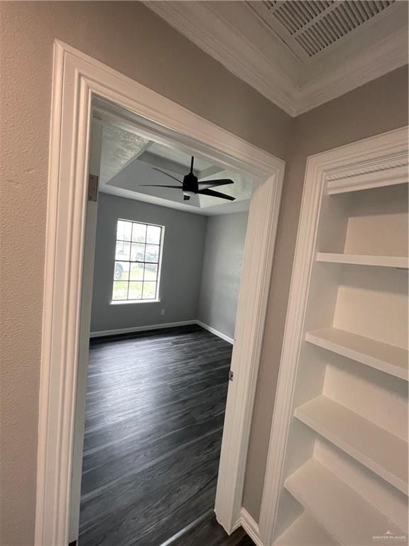 interior space with ceiling fan, dark hardwood / wood-style flooring, and crown molding