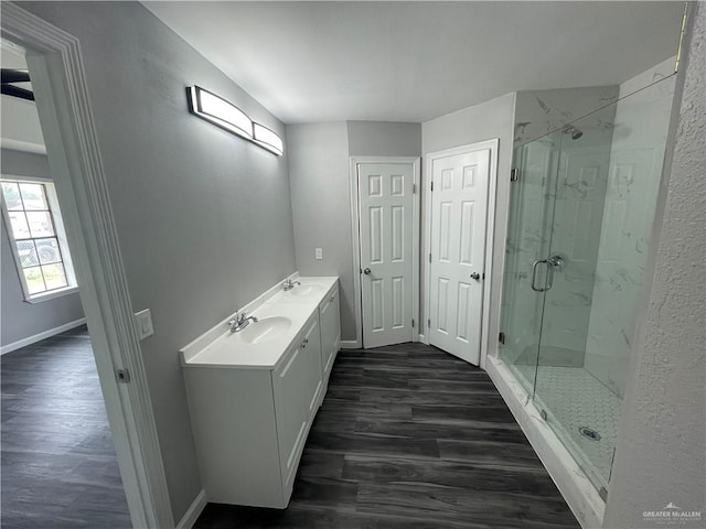 bathroom featuring vanity, hardwood / wood-style flooring, and a shower with shower door