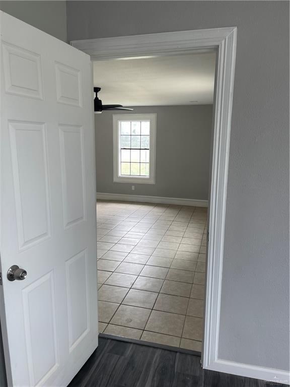 empty room with wood-type flooring and ceiling fan